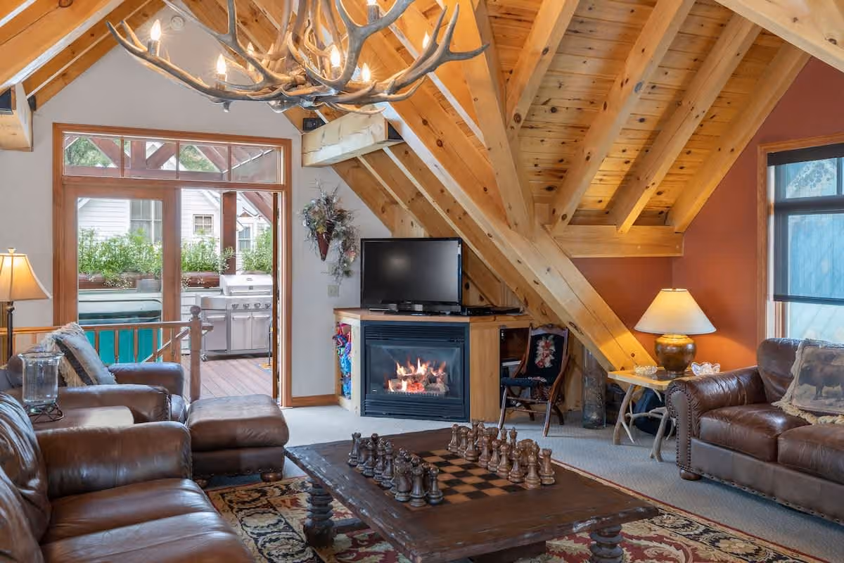 Third-floor sitting room — fireplace under vaulted pine